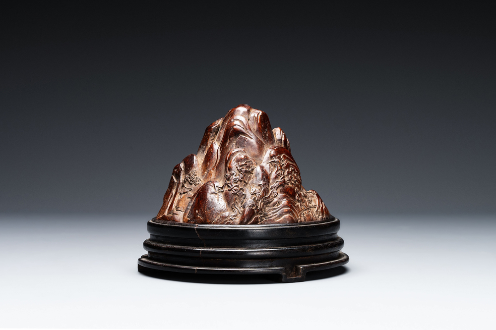 A Chinese agarwood carving of a mountain on wooden stand, 18/19th C.