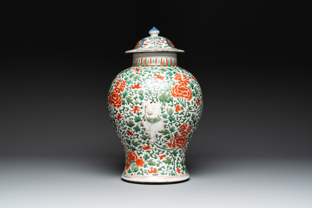 A Chinese wucai 'boy and peony scroll' vase and cover, 17th C.