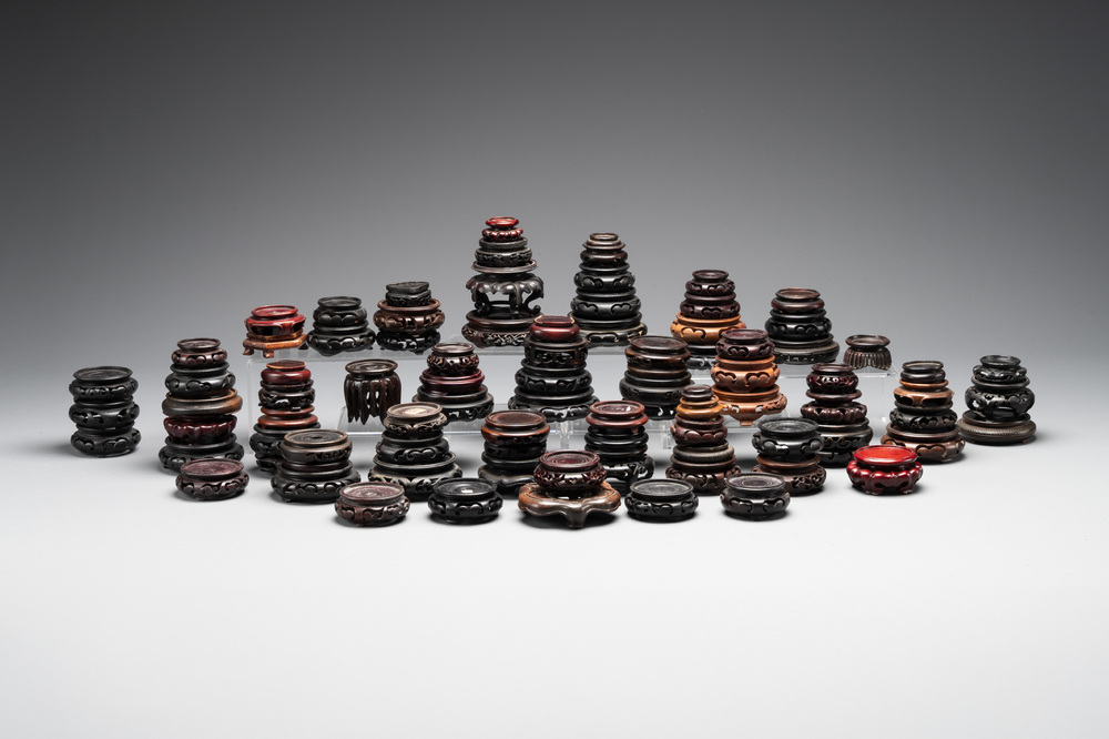A large collection of 91 Chinese wooden stands, 19/20th C.