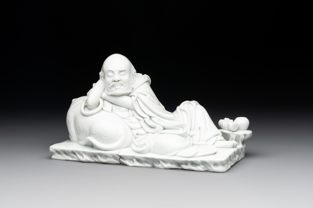 A Chinese Dehua blanc de Chine figure of a Luohan reclining on a tiger, Dehua and Bo Ji Yu Ren 博及漁人 mark, 20th C.