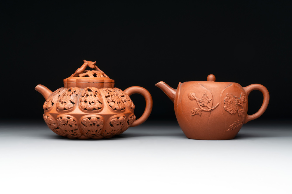 A Chinese Yixing stoneware reticulated double-walled teapot and a teapot with floral relief design, Kangxi