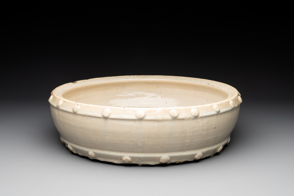 A large Chinese cream-glazed drum-shaped basin, Ming