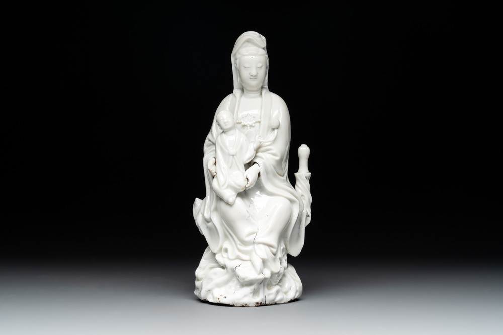 A Chinese Dehua blanc de Chine figure of Guanyin with a boy, Kangxi/Qianlong