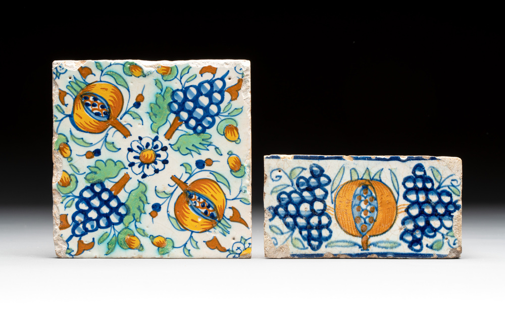 A polychrome and a 'border' Dutch Delft tile with pomegranates and grapes, 1st half 17th C.
