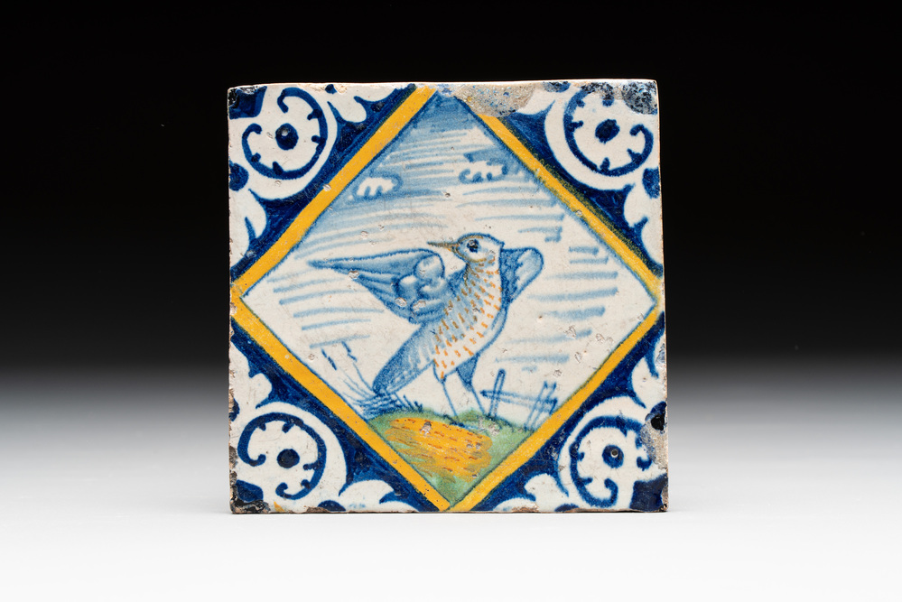 A fine polychrome Dutch Delft maiolica 'bird' diamond tile with a trial drawing on the back, late 16th C.