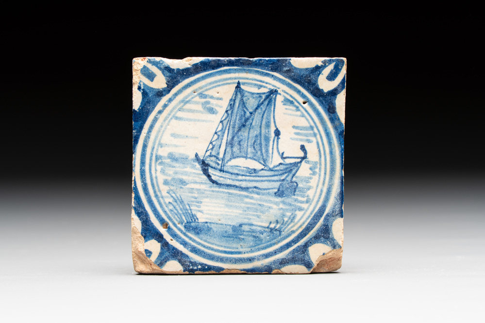 A small blue and white Dutch Delft 'boat' medallion tile, late 16th C.