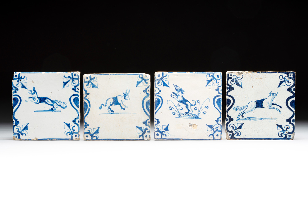 Four blue and white Dutch Delft 'animals' 'candelabra' tiles, 17th C.