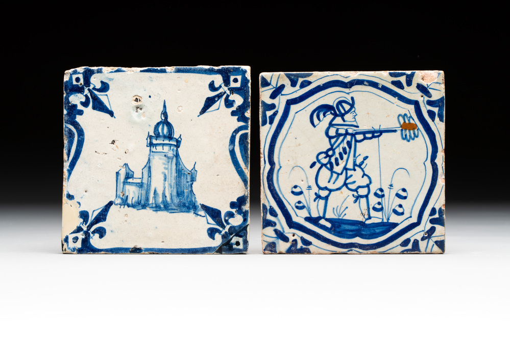 Two blue and white Dutch Delft 'castle' and 'soldier with coloured flame' tiles, 17th C.