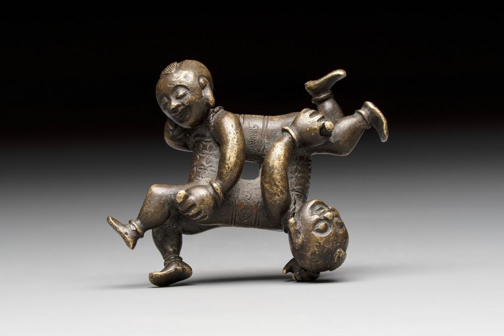 A Chinese bronze scroll weight in shape of two boys, Qing