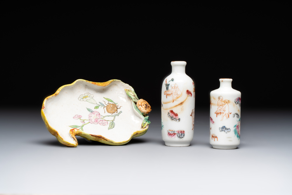 Two Chinese famille rose 'erotic' snuff bottles and a leaf-shaped saucer, 19th C.