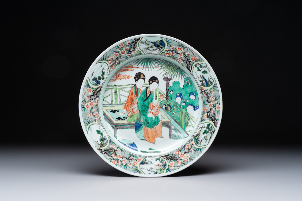 A Chinese famille verte dish with two ladies and a boy holding a lotus, artemisia leaf mark, Kangxi