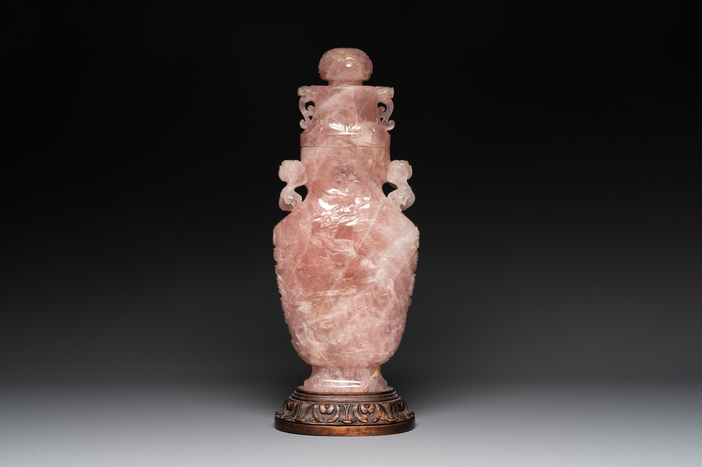 A large Chinese rose quartz vase and cover on a wooden stand, 20th C.