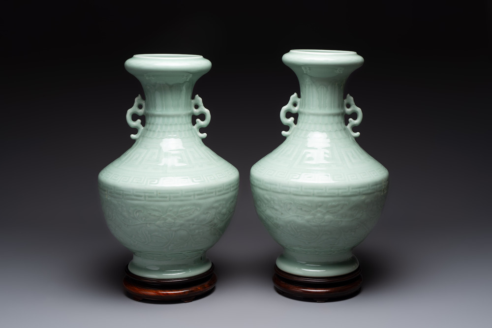 A pair of Chinese celadon-glazed vases with 'anhua' design on wooden stands, Qianlong mark, 19th C.