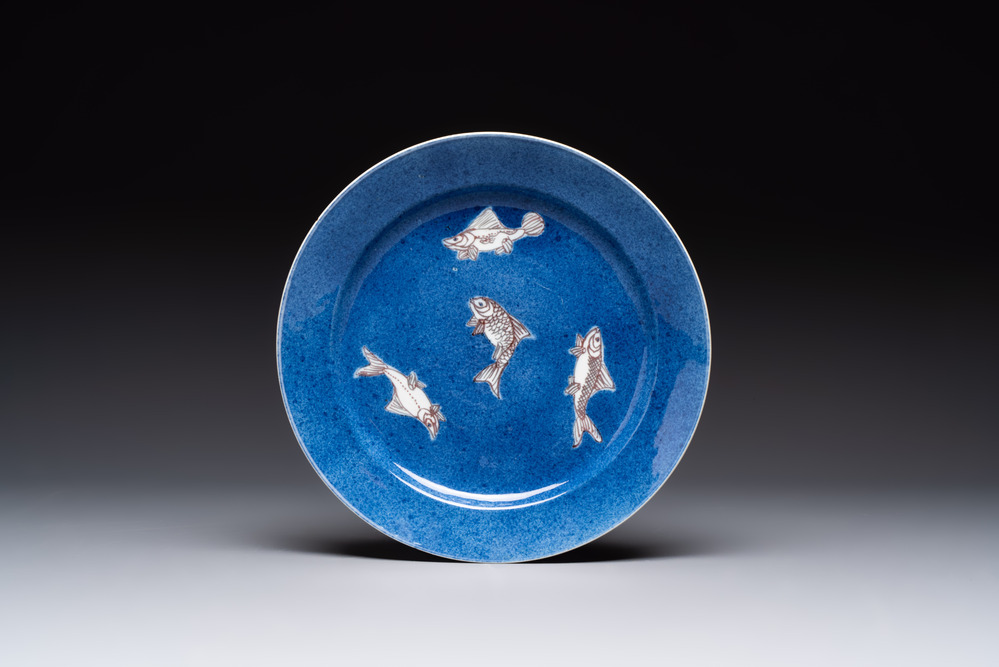 A Chinese blue, white and copper-red powder-blue-ground 'fish' dish, Kangxi