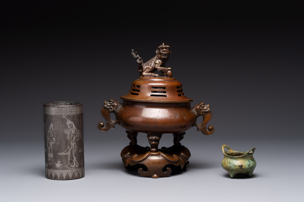 A Chinese bronze tripod censer with cover and stand, a small tripod censer and a silver-inlaid iron brush pot, 19/20th C.