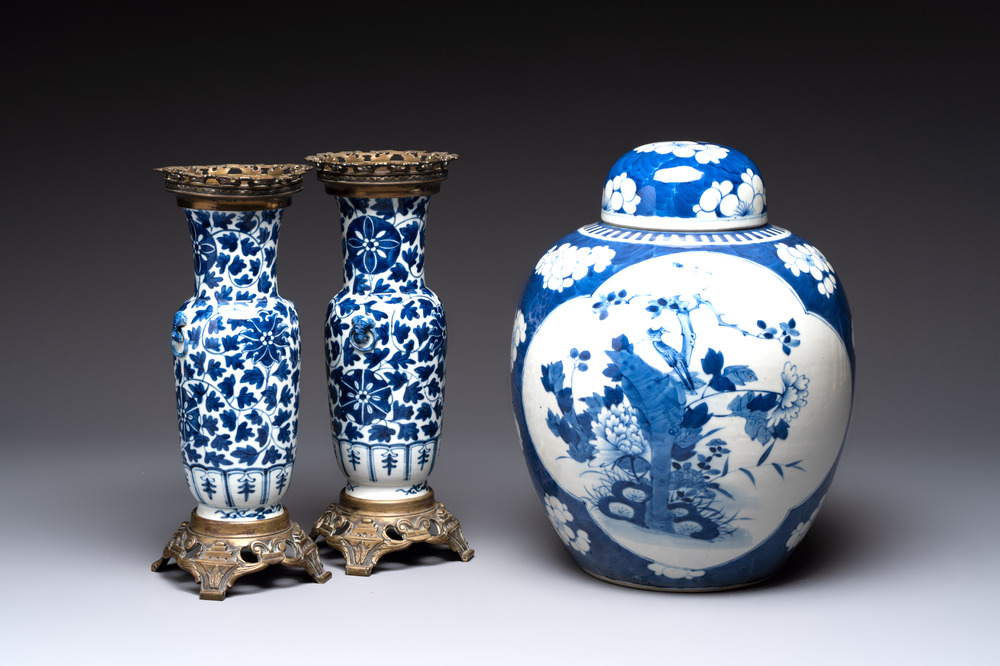 A pair of Chinese blue and white bronze-mounted vases and a covered jar, 19th C.