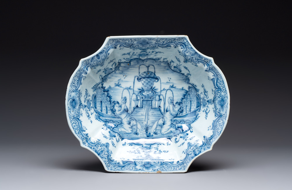 A blue and white Dutch Delft basin with putti near a fountain, 18th C.