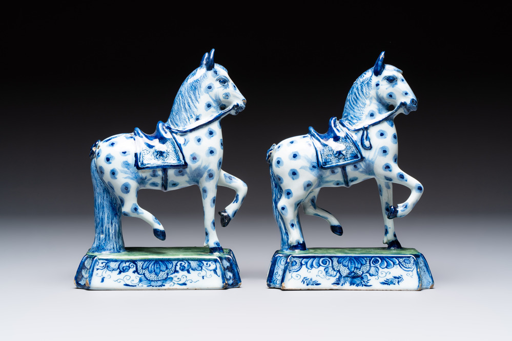 A pair of blue and white Dutch Delft prancing horses on a green-glazed base, 18th C.