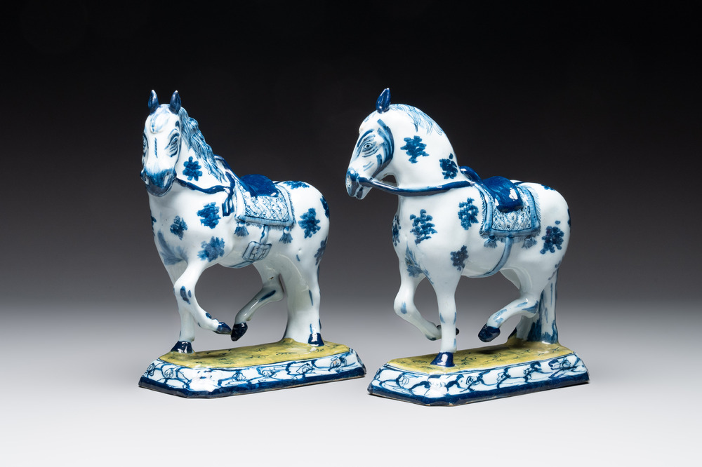 A fine pair of blue and white Dutch Delft horses on a green base, 18th C.