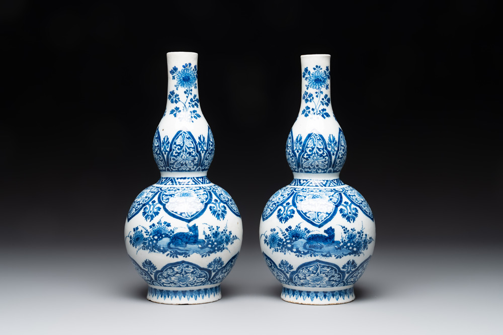 A pair of blue and white Dutch Delft double gourd vases with leopards, late 17th C.