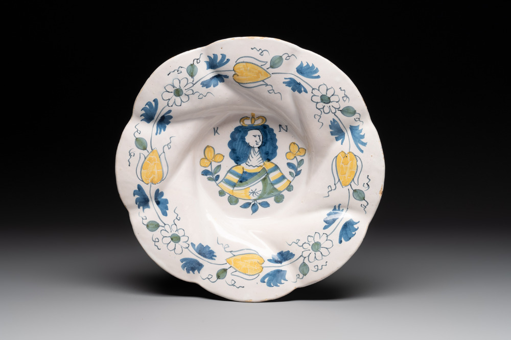 A polychrome Dutch Delft twisted 'Queen Mary' dish, erroneously inscribed K N, 17th C.