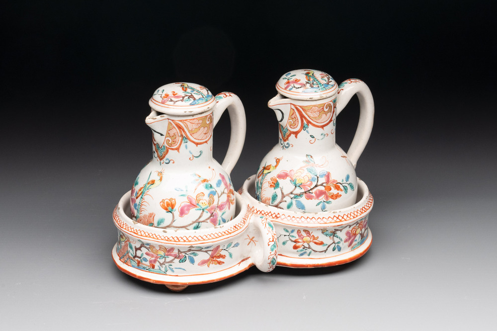 A rare polychrome Dutch Delft petit feu cruet set of two jugs and covers on a stand, 18th C.