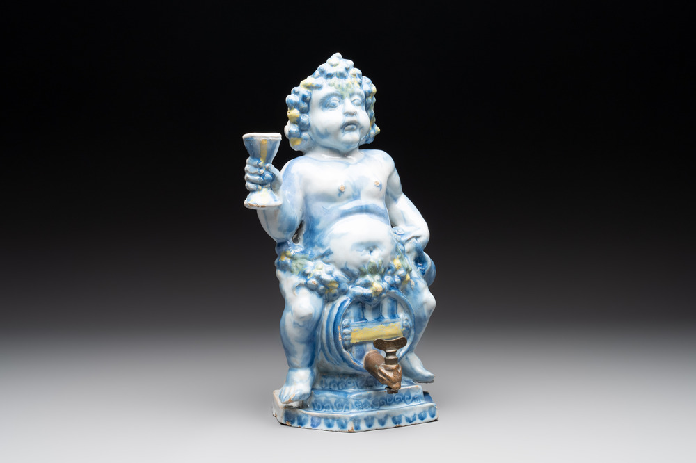 A polychrome Dutch Delft table fountain in the shape of Bacchus on a barrel, early 18th C.