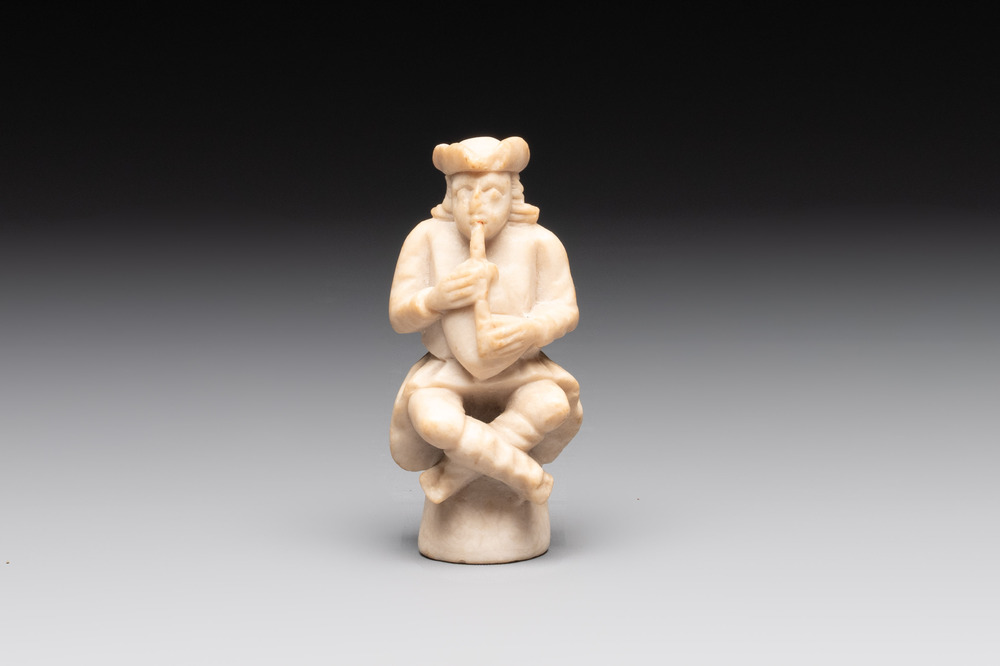 A carved alabaster figure of a seated bagpiper, Low Countries, possibly 17th C.
