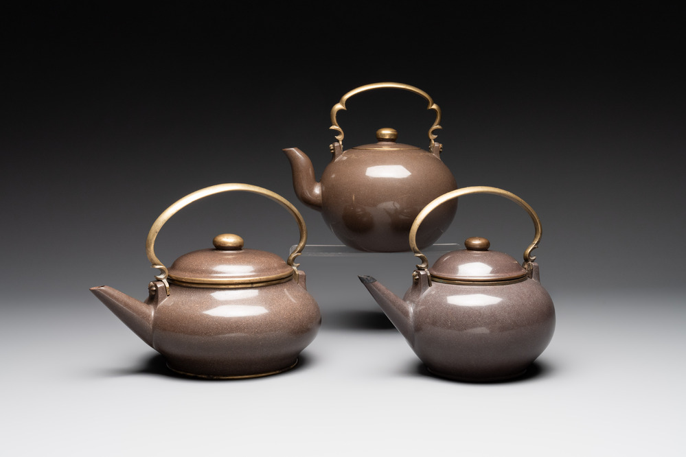 Three Chinese Thai market polished Yixing stoneware teapots with brass mounts, 19th C.