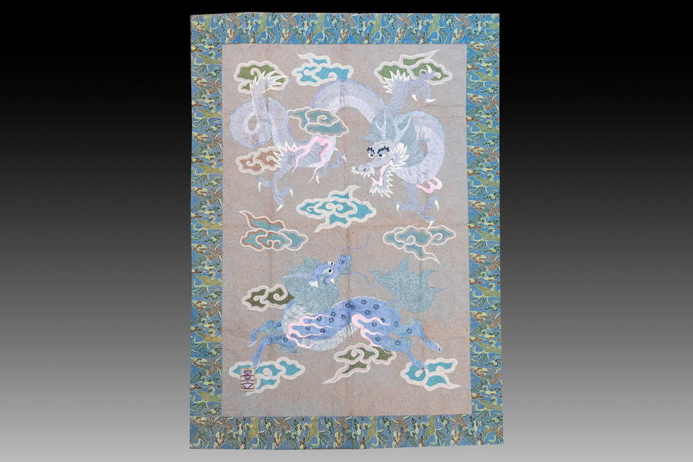 A Japanese embroidered wool and silk wall tapestry with a dragon and qilin, Meiji, 19th C.