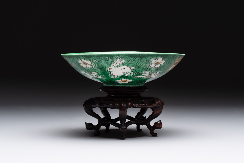 A Chinese verte biscuit 'animals among waves' bowl and a wooden stand, Jiajing mark, Kangxi