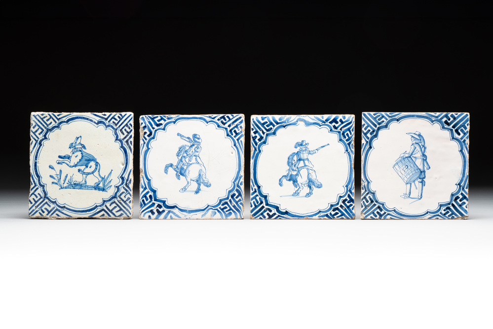 Four blue and white Dutch Delft 'horserider', 'drummer' and 'dog' tiles, 17th C.