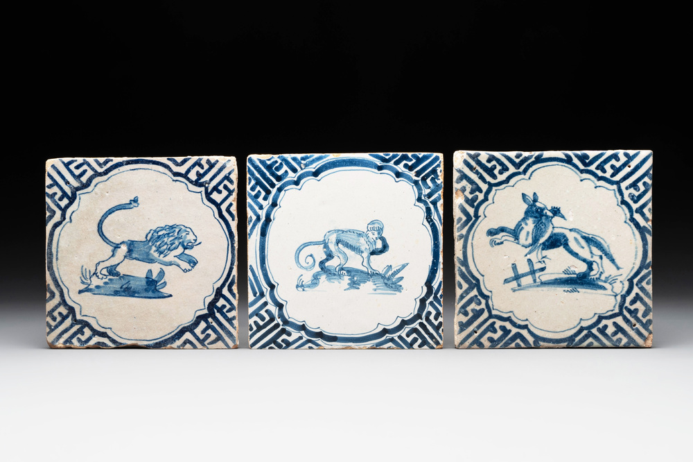 Three blue and white Dutch Delft tiles with a monkey, a lion and a fox with its prey, 17th C.