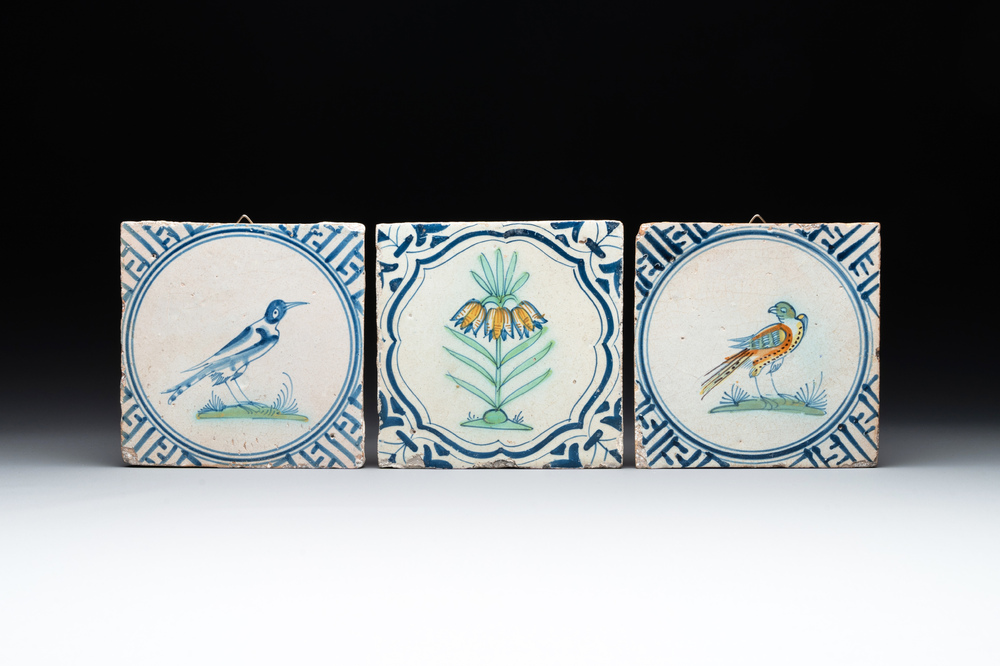 Three polychrome Dutch Delft 'flower' and 'bird' tiles, 17th C.