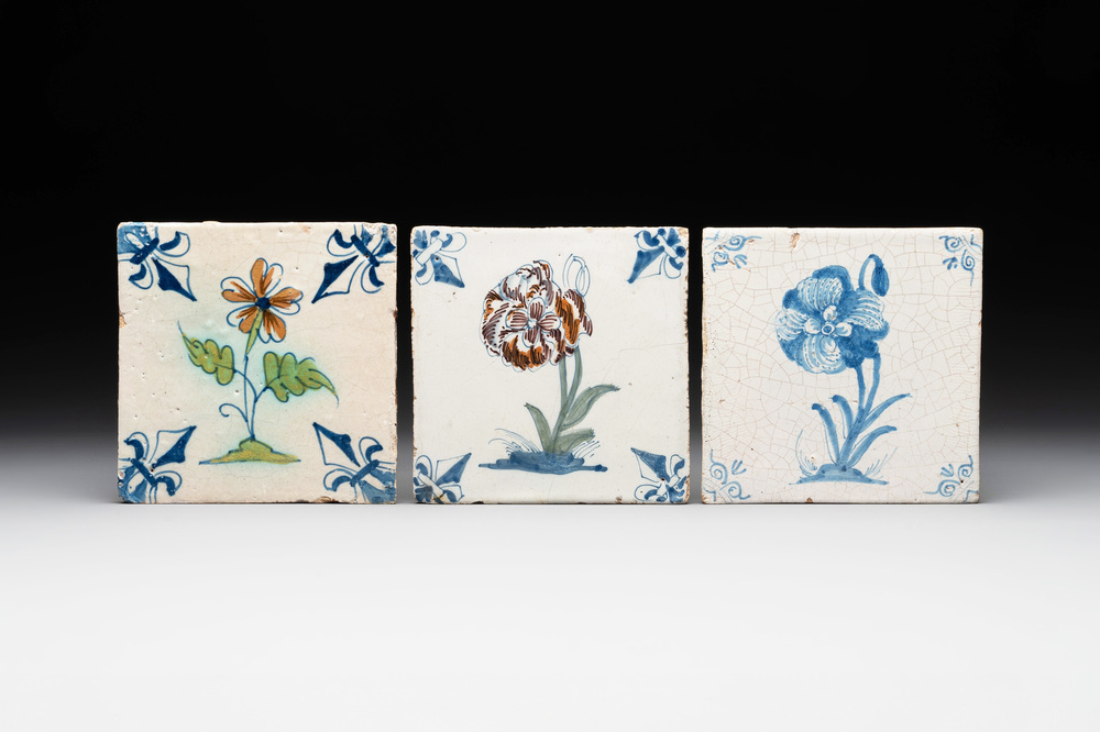 Two polychrome and one blue and white Dutch Delft 'flower' tiles, 17th C.
