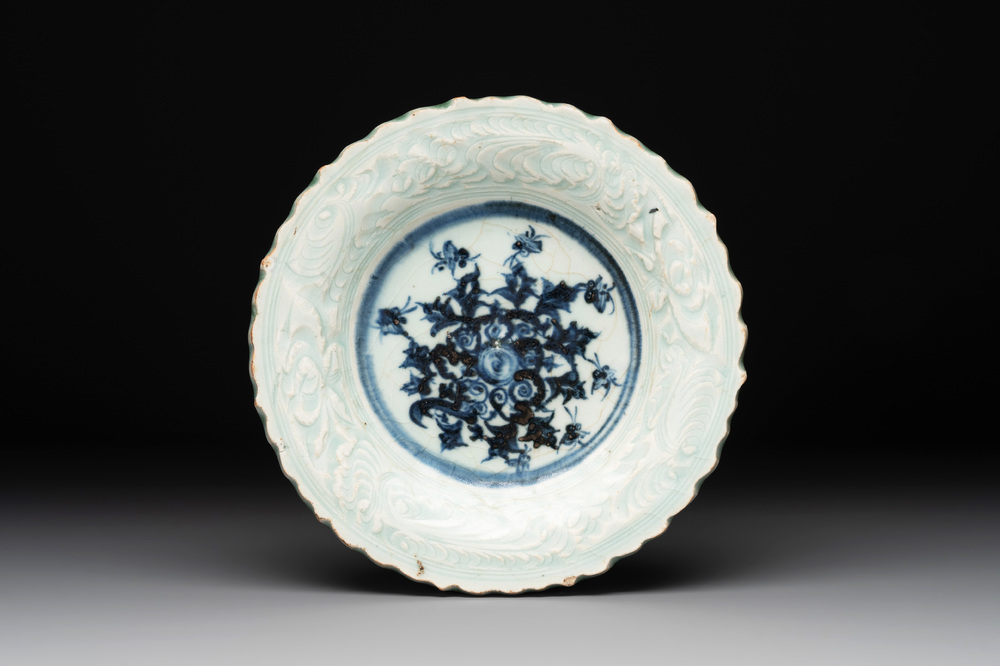 A Chinese blue and white celadon-ground plate with floral design, Ming
