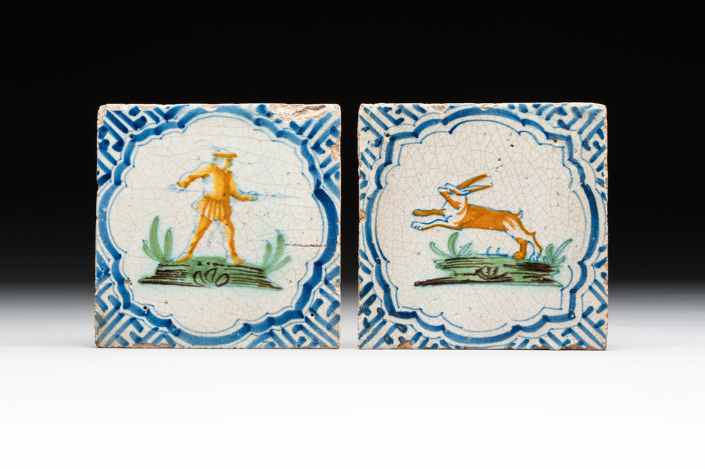 Two polychrome Dutch Delft 'accolade borders' 'hunter' and 'hare' tiles, 17th C.