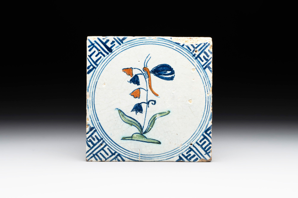 A polychrome Dutch Delft 'butterfly on a campanula' tile, 17th C.