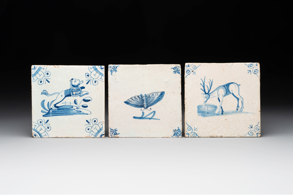 Three blue and white Dutch Delft tiles with a lion, a butterfly and a deer, 17th C.