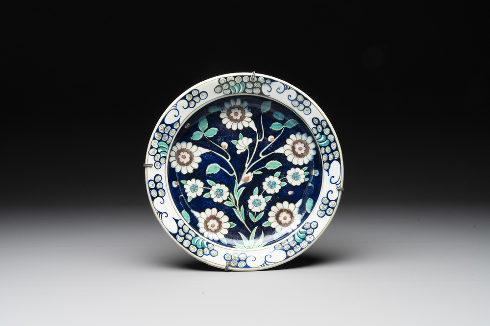 An inscribed blue-ground Iznik-style dish, 19th C.