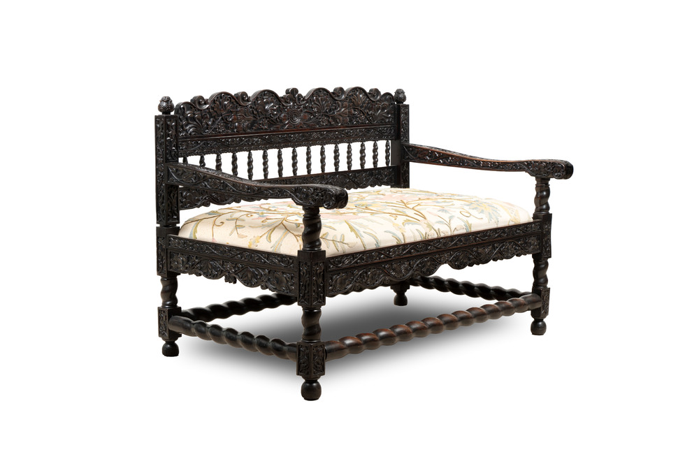 A Dutch colonial carved and ebonized wooden bench, 18th C.