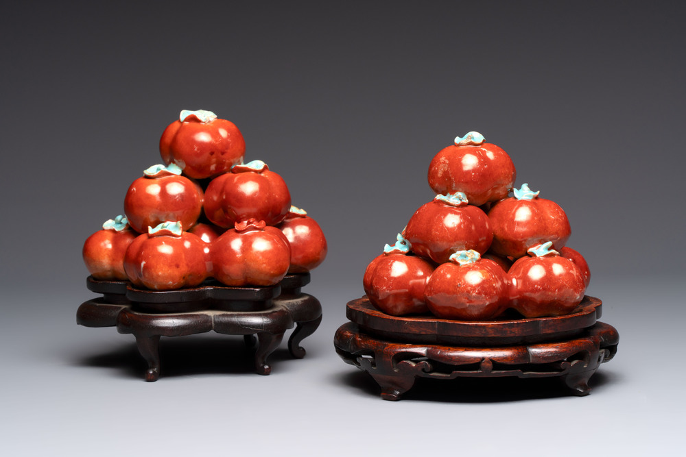 A pair of Chinese polychrome 'persimmons' groups on wooden stands, 19th C.