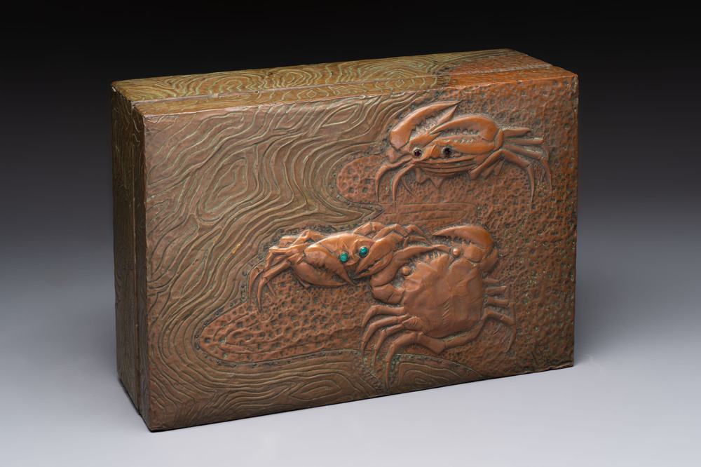Alfred Daguet (Paris, 1875-1942): An Art Nouveau repouss&eacute; brass- and copper-mounted box with 'crabs' design and inset glass eyes, ca. 1900