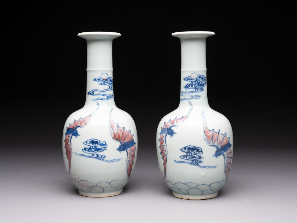 A pair of Chinese blue, white and copper-red 'bats among the clouds' vases, 19th C.