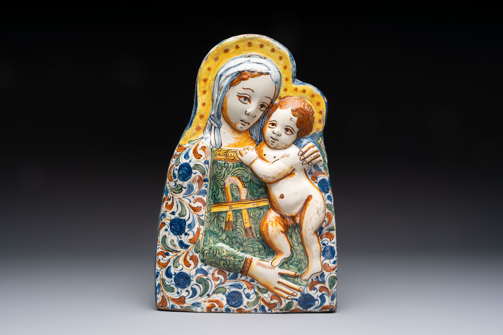 A polychrome molded Italian maiolica 'Madonna and Child' plaque, 17th C.
