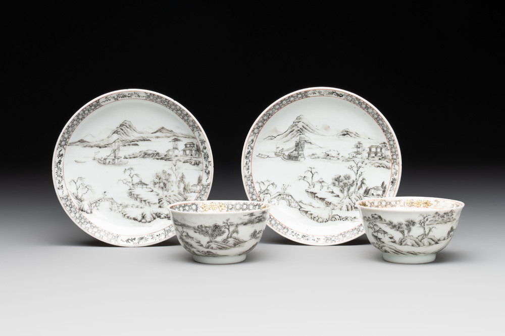 A pair of Chinese grisaille and iron-red 'landscape' cups and saucers, Yongzheng/Qianlong