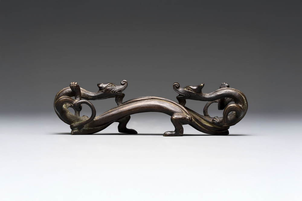 A Chinese bronze 'dragon' brush rest, Song/Yuan