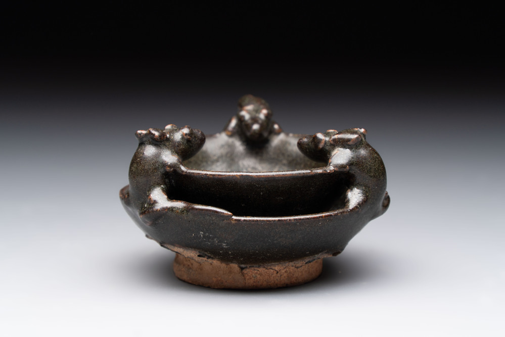 A rare Chinese black-glazed two-tier oil lamp with three rats, Ming