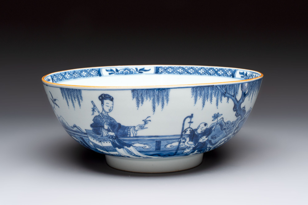 A Chinese blue and white punch bowl with a lady and two boys in a garden, Qianlong