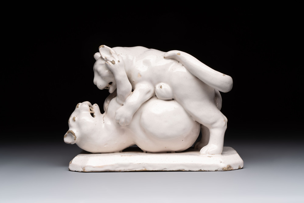 A rare white-glazed Delftware group of two fighting felines, early 18th C.